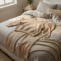 Cozy lounge set with oversized sweatshirt and wide-leg pants in oatmeal color on soft linen bedding